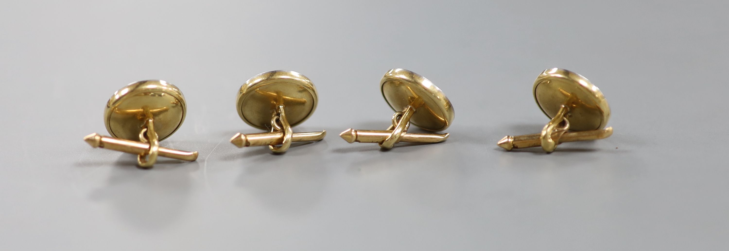 A set of four yellow metal (engraved 14), mother of pearl and seed pearl set dress studs